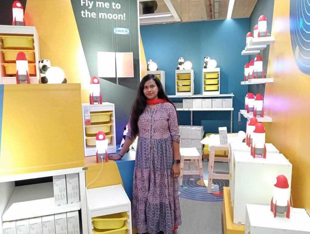 Professional founder portrait of Neelu Chocos with a confident smile and premium chocolate brand background.